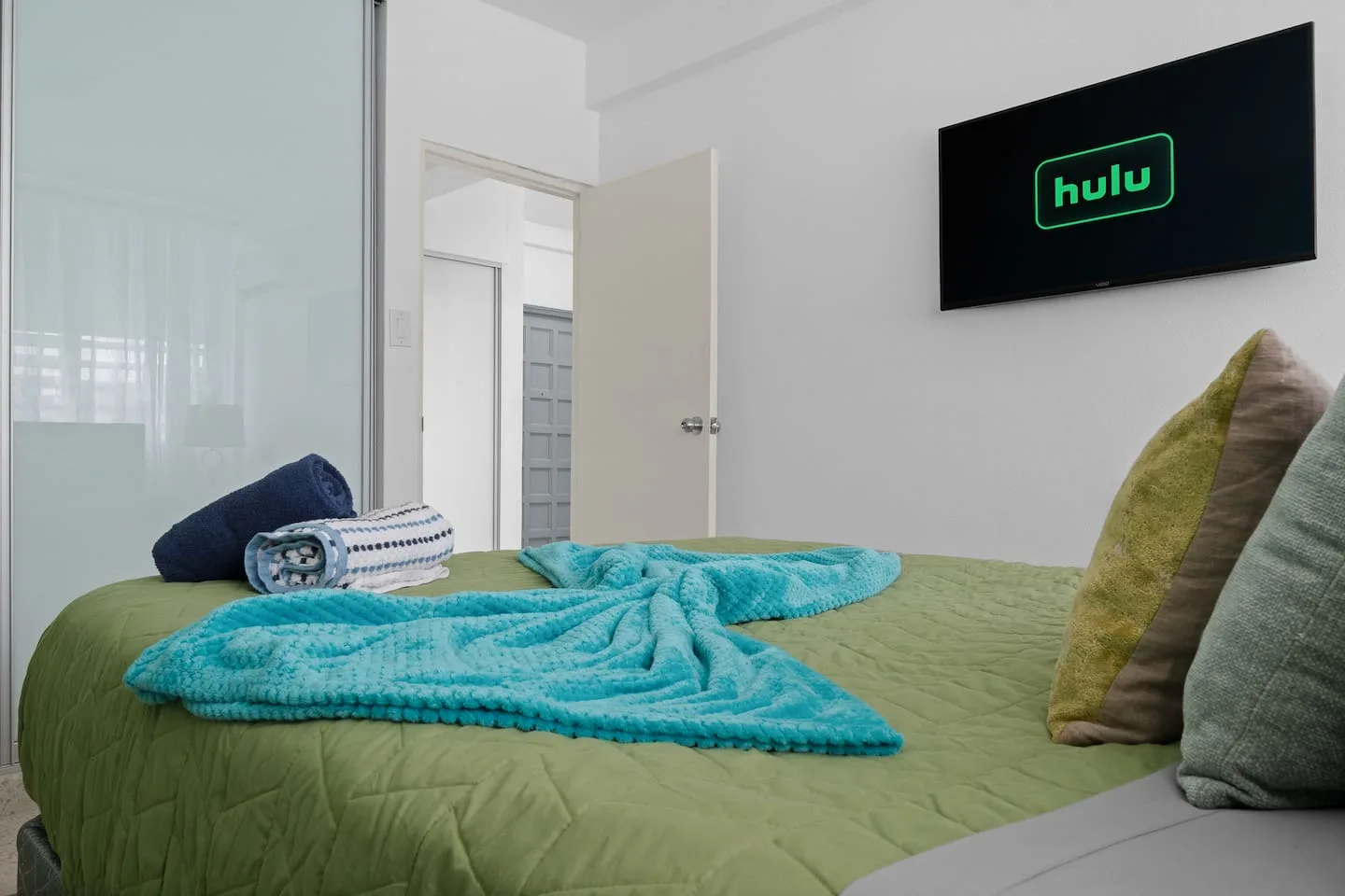 Bedroom with a bed and a blue blanket on it — Maré 2BR | Near Ocean Park Beach + Laundry, Santurce