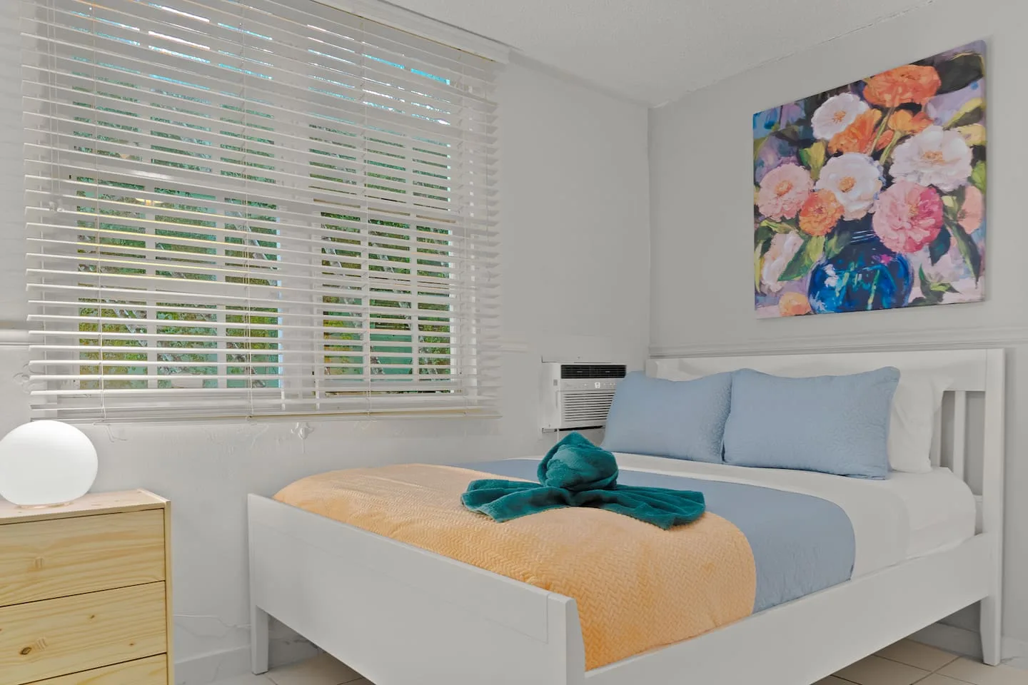 Bedroom with a white bed and a painting on the wall — San Juan 2BR | Sleeps 7 + Balcony & Laundry, Santurce