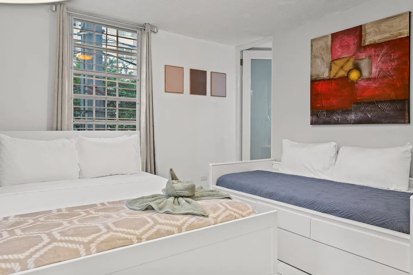 Bedroom with two beds and a window — San Juan 2BR | Sleeps 7 + Balcony & Laundry, Santurce
