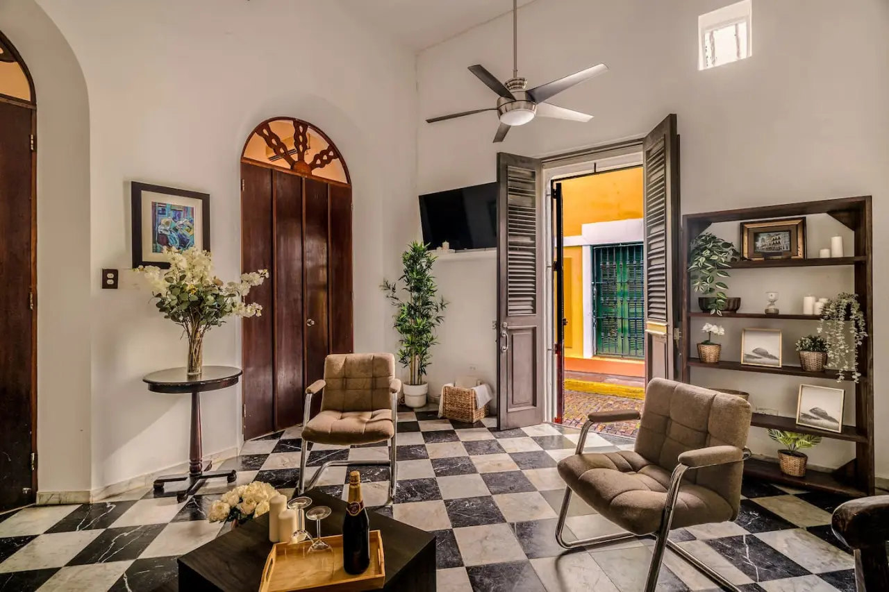 Living room with a couch and a TV — Ocean Breeze | Old San Juan | Spanish Style
