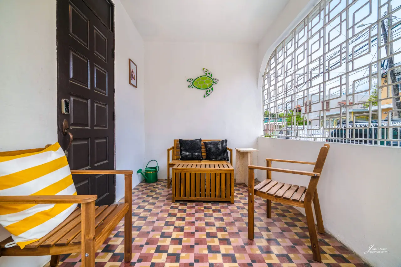 Covered patio with wooden chairs and patterned tile — Villa Blanca | San Juan | La Plácita, Miramar