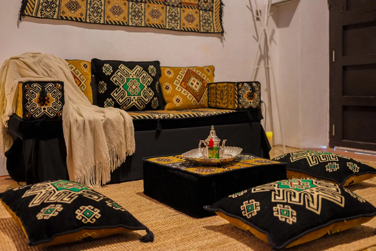 Living room sofa with Moroccan cushions and a tea set — Morocco Loft Sanjuanero | Viejo San Juan, Old San Juan