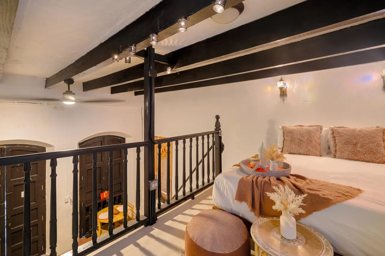 Loft bedroom with a railing and wood beams — Morocco Loft Sanjuanero | Viejo San Juan, Old San Juan