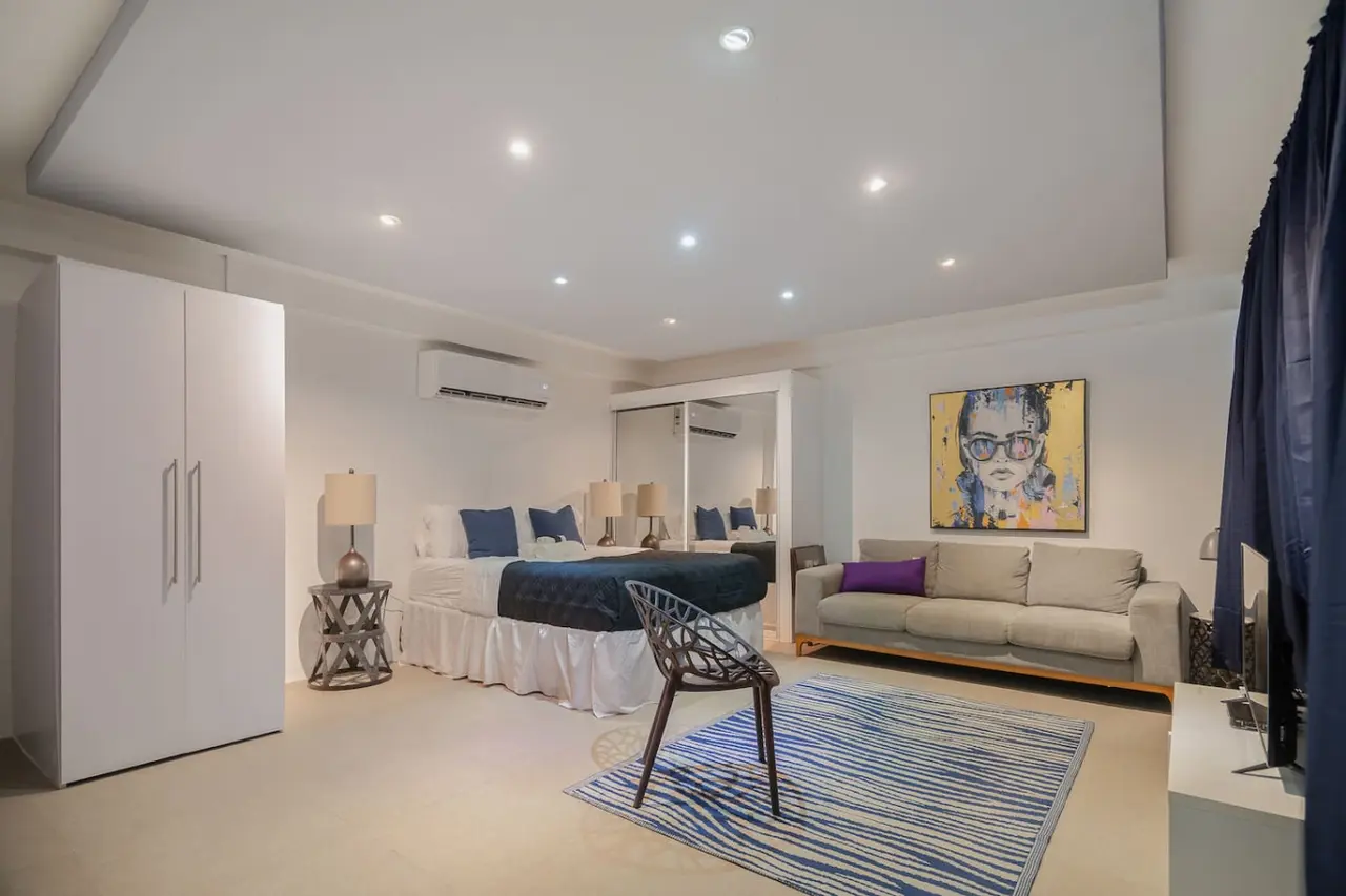 Bedroom with a bed and a chair — Punta Las Marias Studio - Short Walk to the Beach, Santurce