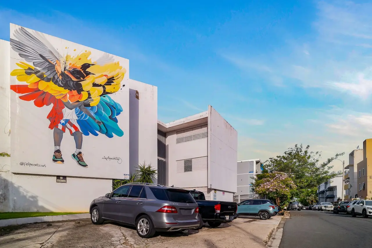 Building with a large mural of a winged figure — Punta Las Marias Studio - Short Walk to the Beach, Santurce