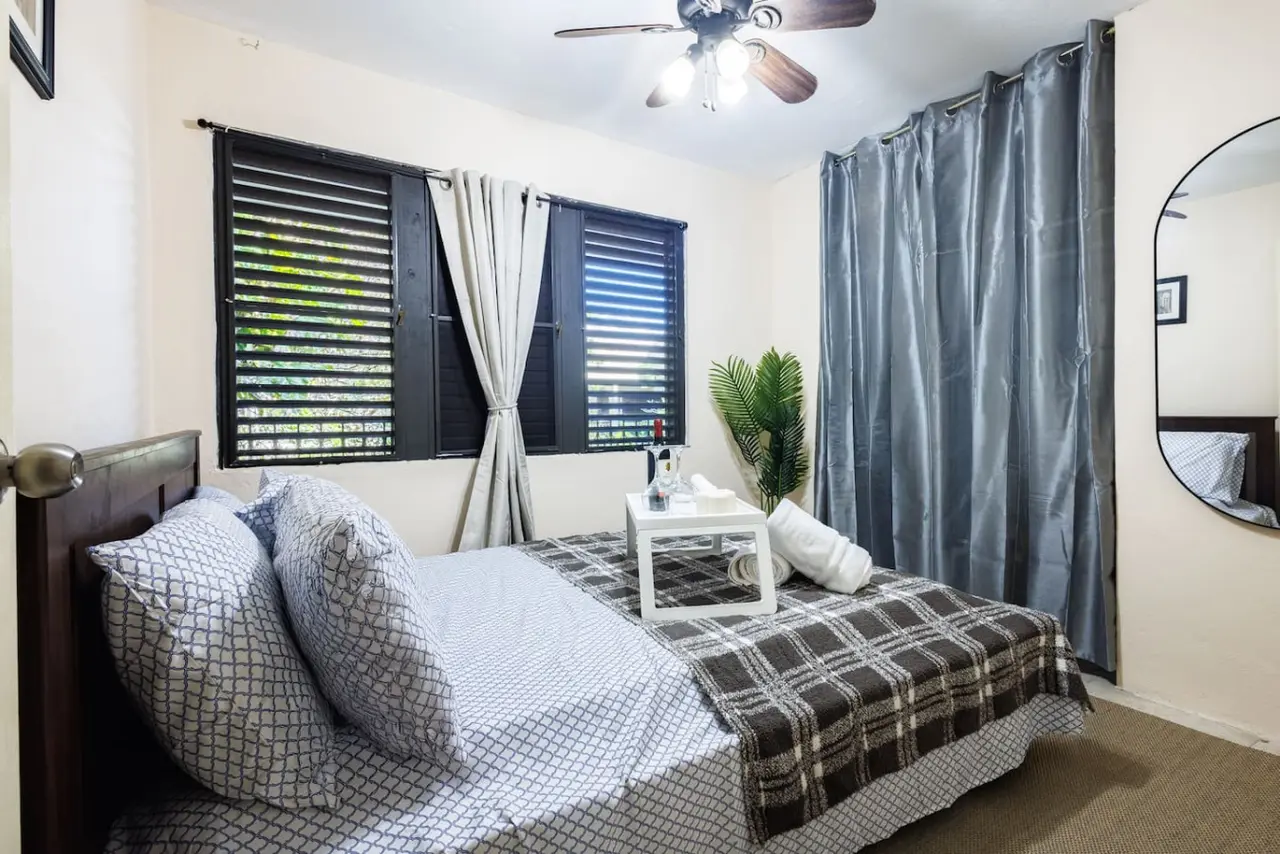 Bedroom with a bed and a table — Ocean Sol Historic Old San Juan