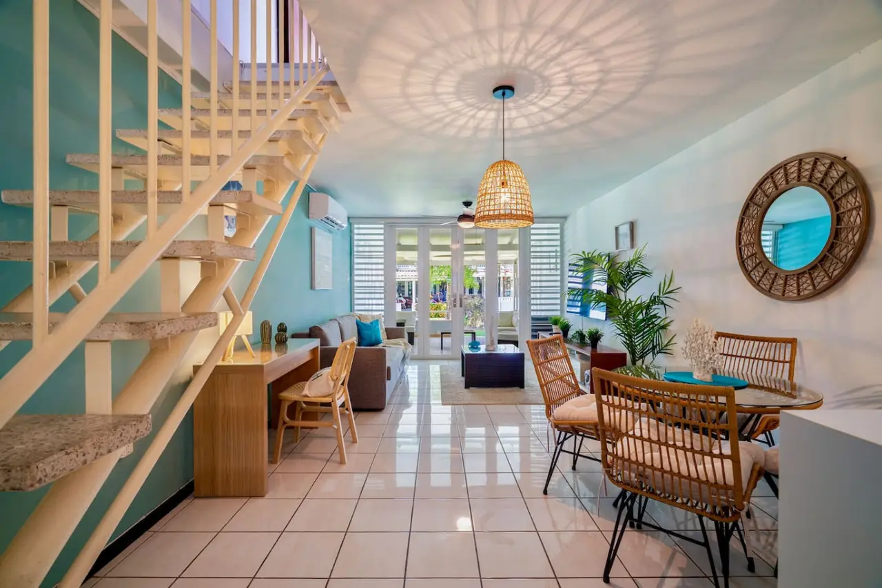 Living area with a staircase and a dining table — Beach Villa Dorado Del Mar