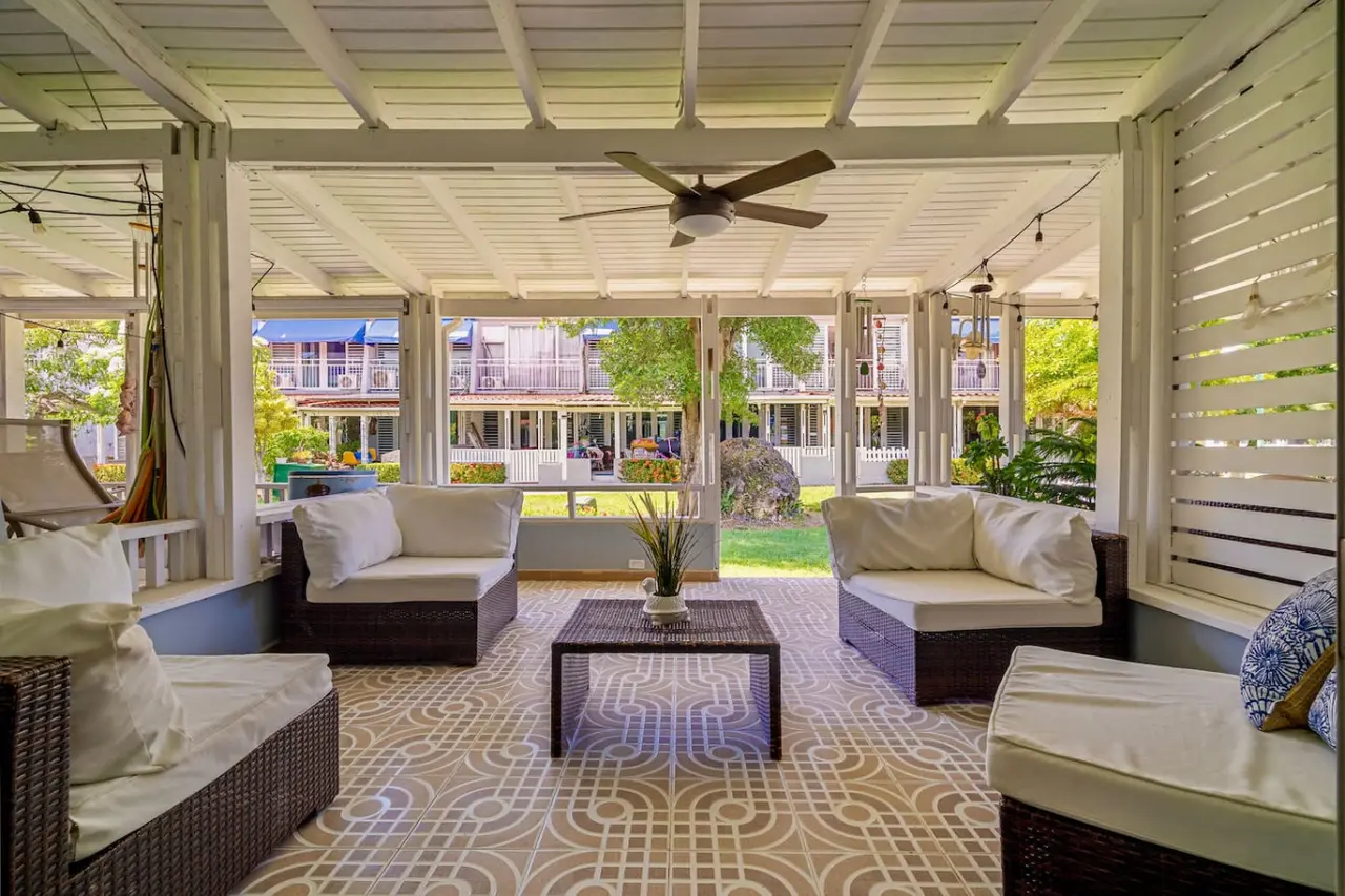 Covered patio with wicker sofas and a ceiling fan — Beach Villa Dorado Del Mar