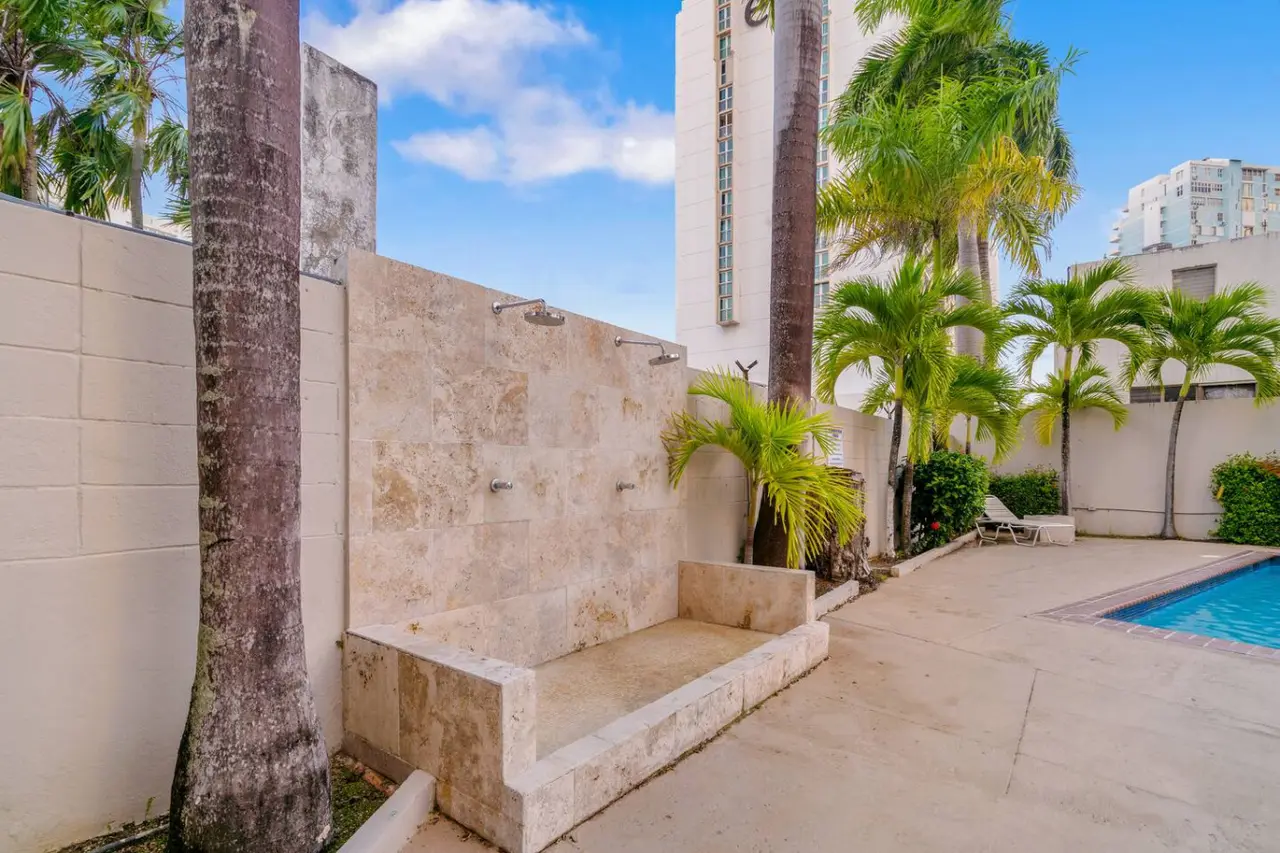 Outdoor showers on a stone wall by the pool — OceanSide - Pool Balcony, Isla Verde