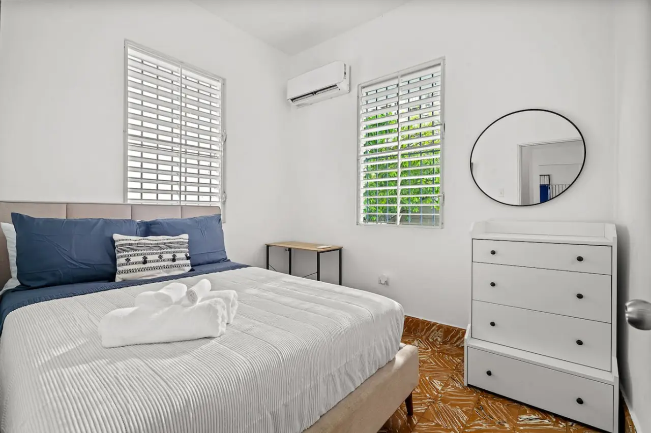 Bedroom with a white bed and blue pillows — Sunkiss in Puerto Rico San Juan 3 Bedroom, Santurce