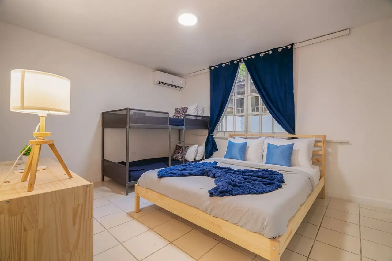 Bedroom with a queen bed and a bunk bed — Condado Grass Patio, Santurce