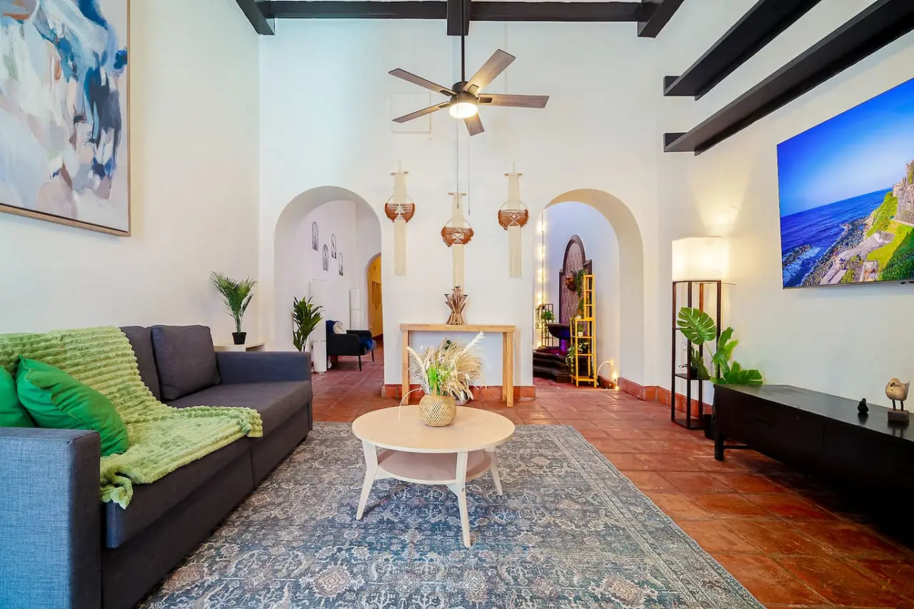 Living room with a couch, a coffee table, and a ceiling fan — Villa Mansion - Fountain & Rooftop - Old San Juan