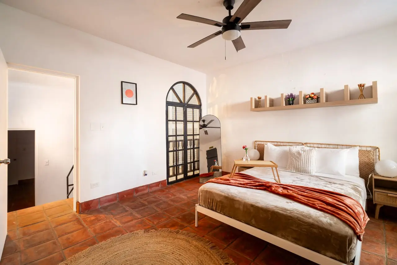 Bedroom with a bed, nightstand, and a ceiling fan — Villa Mansion - Fountain & Rooftop - Old San Juan