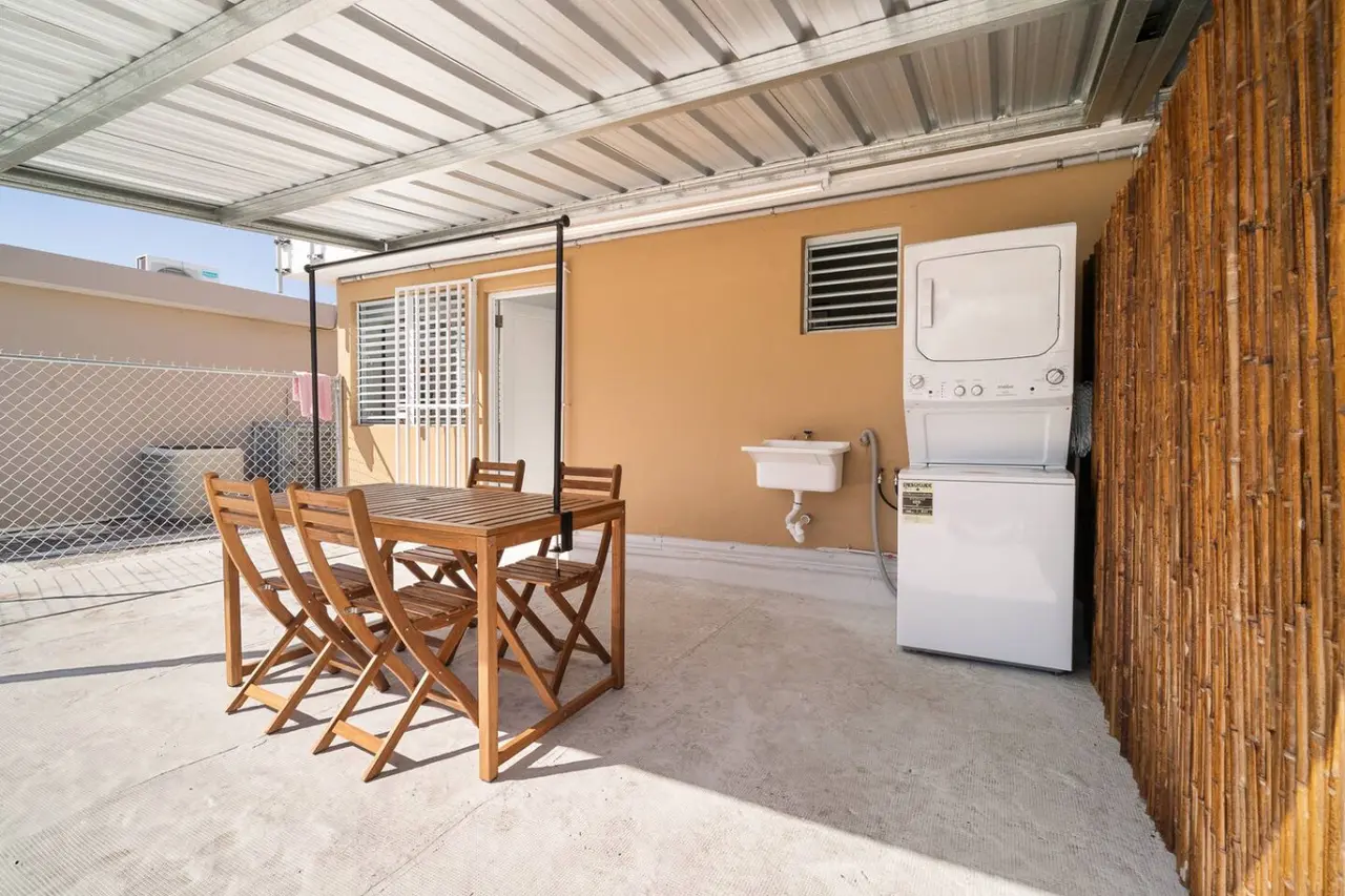 Covered patio with a dining table and a washer-dryer — MoonJoy Chic 2BR Apartment Private Patio, Carolina