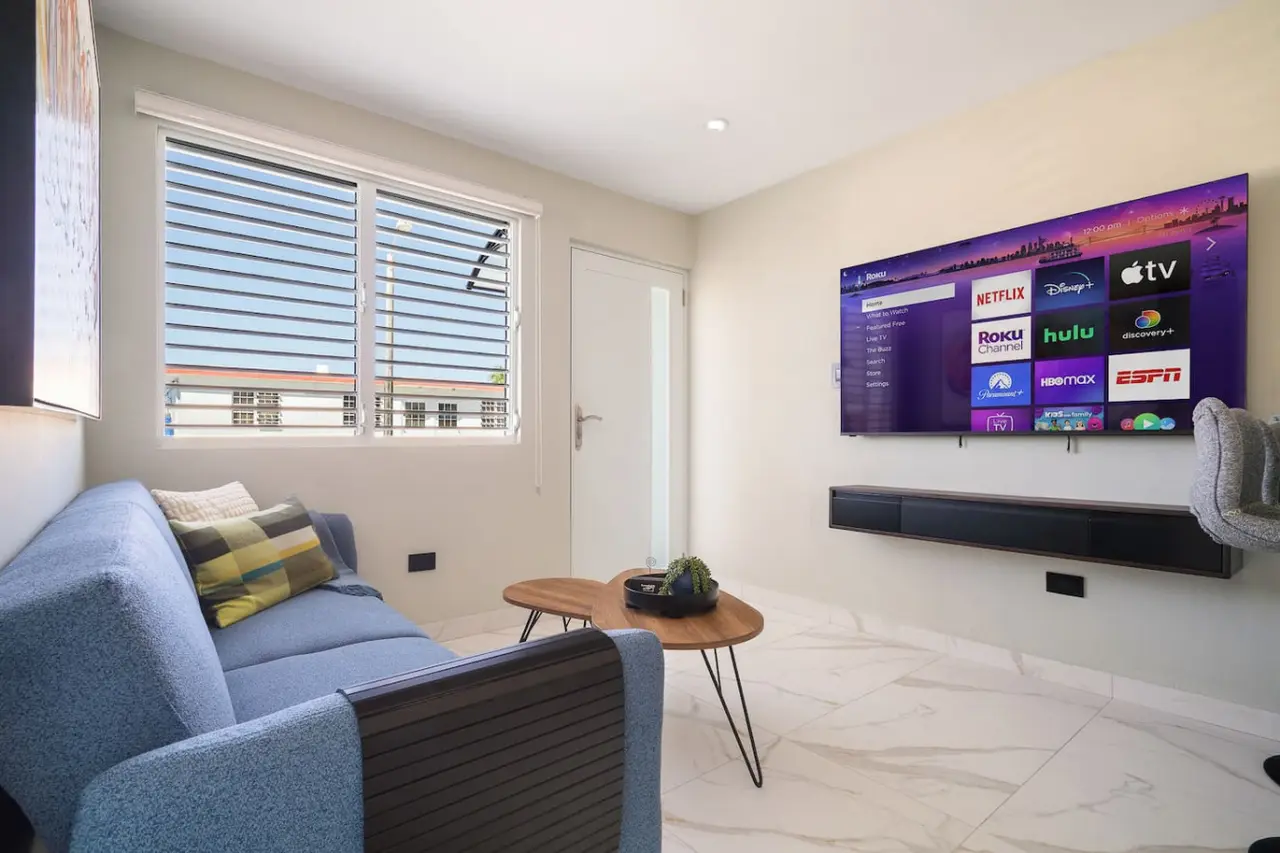 Living room with a wall TV and a round coffee table — MoonJoy Chic 2BR Apartment Private Patio, Carolina
