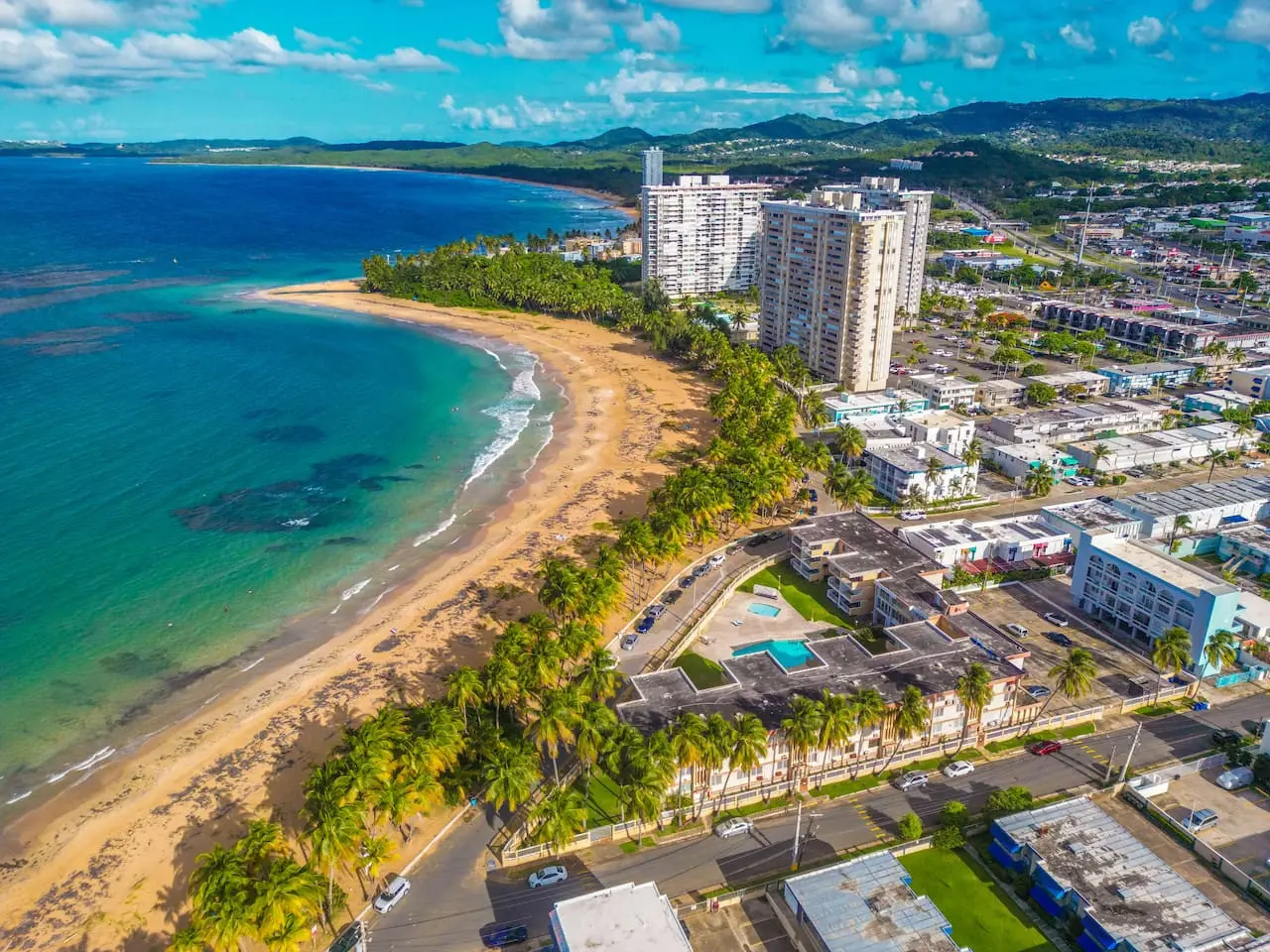 Aerial view of the town's high-rises and palm trees — Walking to the Beach 3 bedroom House Next to Ocean, Luquillo