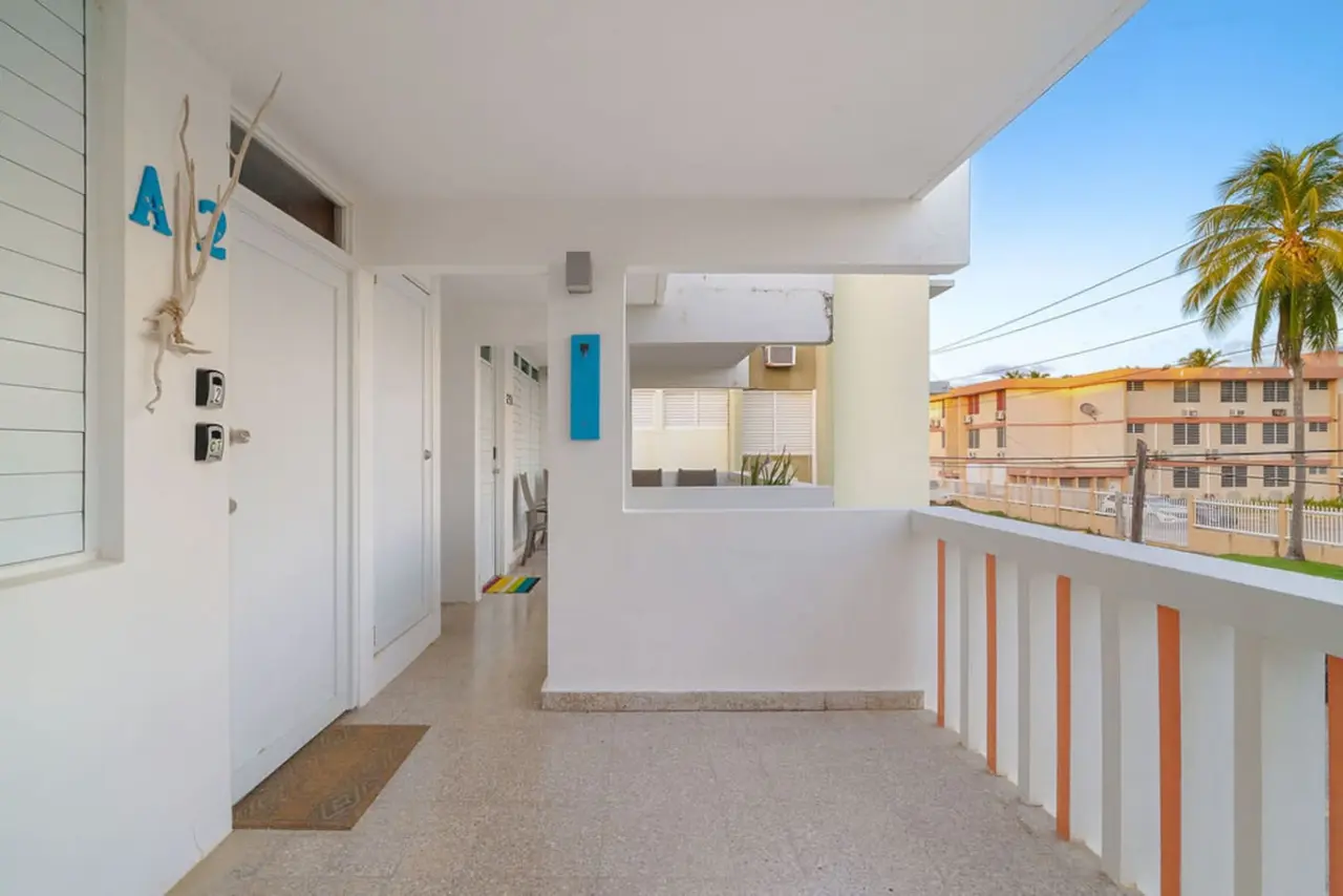 Front terrace walkway with a slatted railing — Walking to the Beach 3 bedroom House Next to Ocean, Luquillo