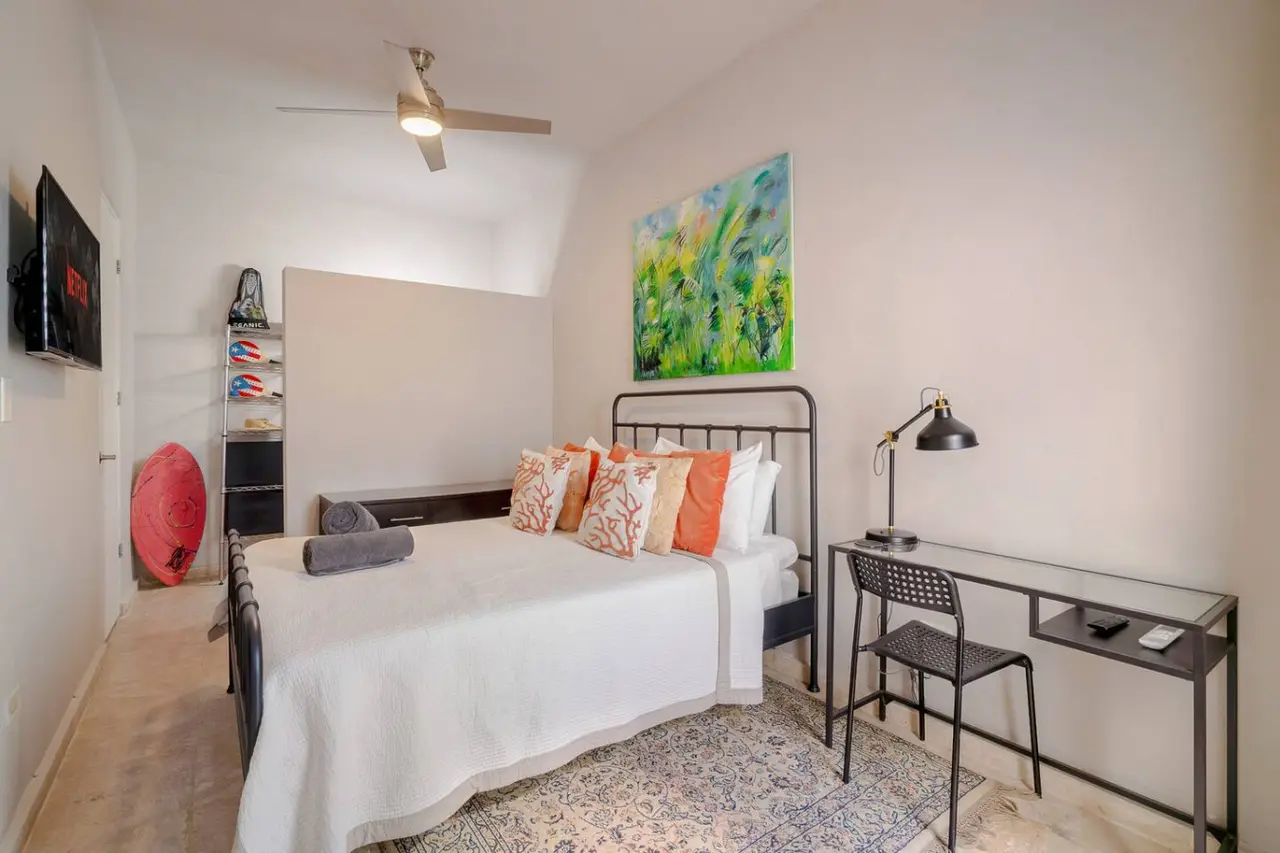 Bedroom with a bed, a lamp, and a painting on the wall — Historical Old San Juan Spanish style private Patio