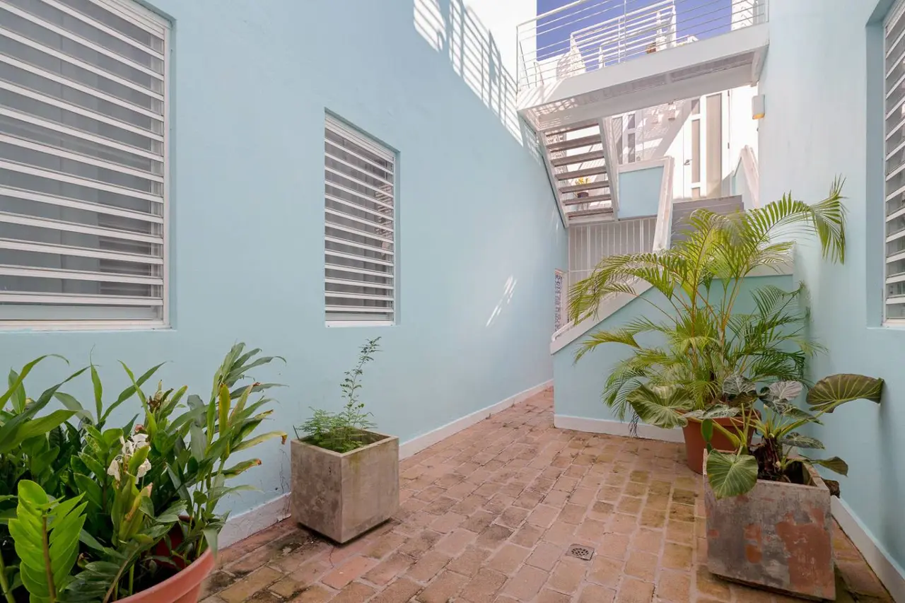 Patio with potted plants and light blue walls — Historical Old San Juan Spanish style private Patio