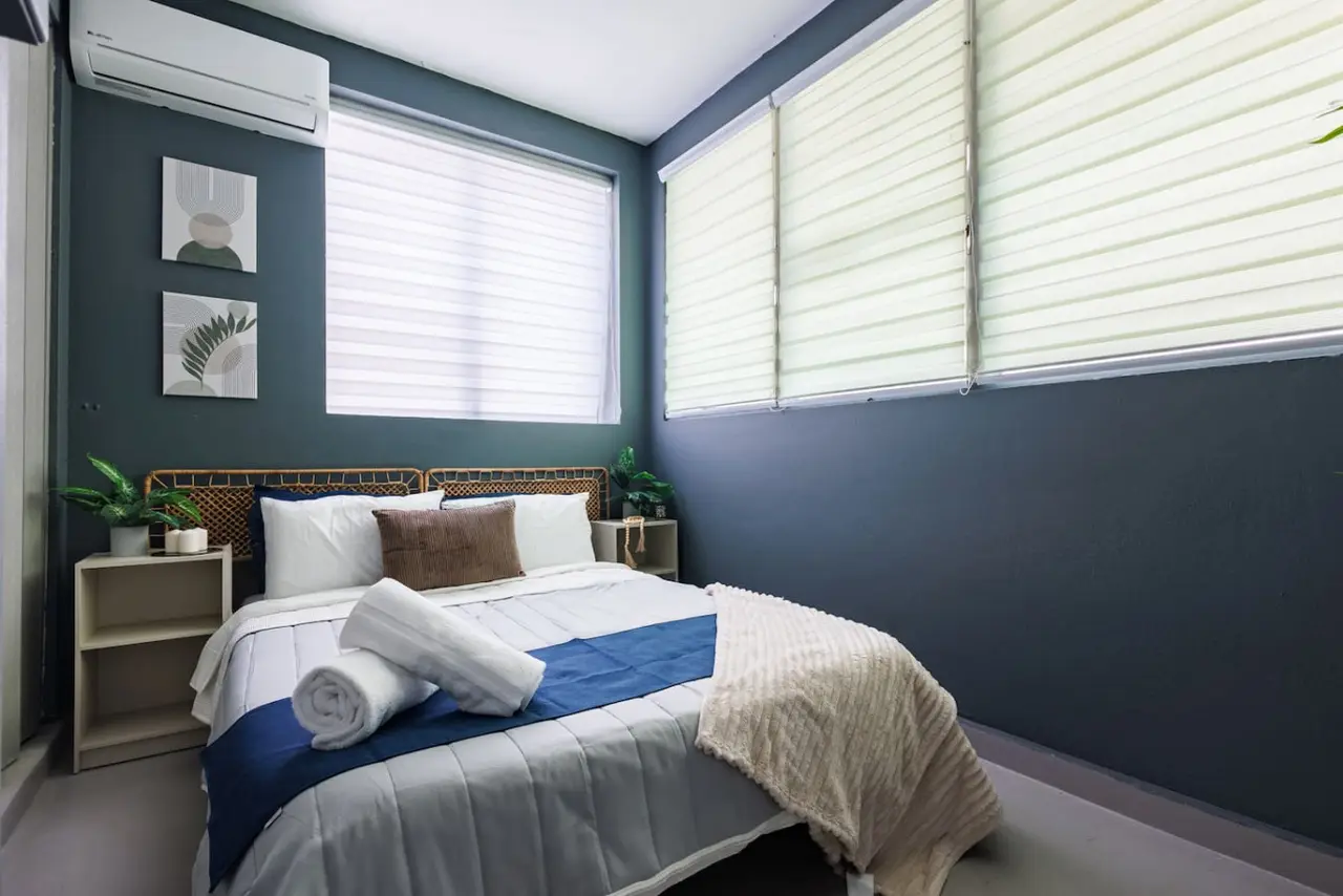 Bedroom with two shaded windows and botanical prints — Spain Lagoon | San Juan | Private Patio, Santurce