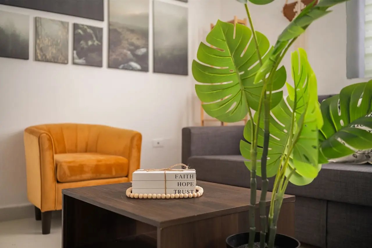 Living room with an orange armchair and a coffee table — Puerto Lagoon Downtown, Santurce