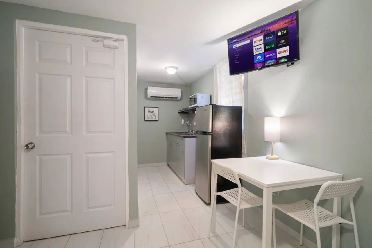 Kitchen with a refrigerator, sink, and microwave — Casa Juno I: Private Courtyard Studio, Santurce
