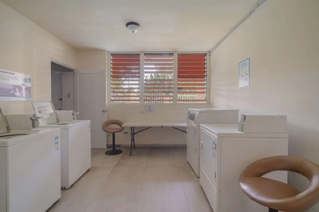 Shared laundry room with washers and dryers — Luxe Beachside Oasis: Pool Parking & Generator, Santurce