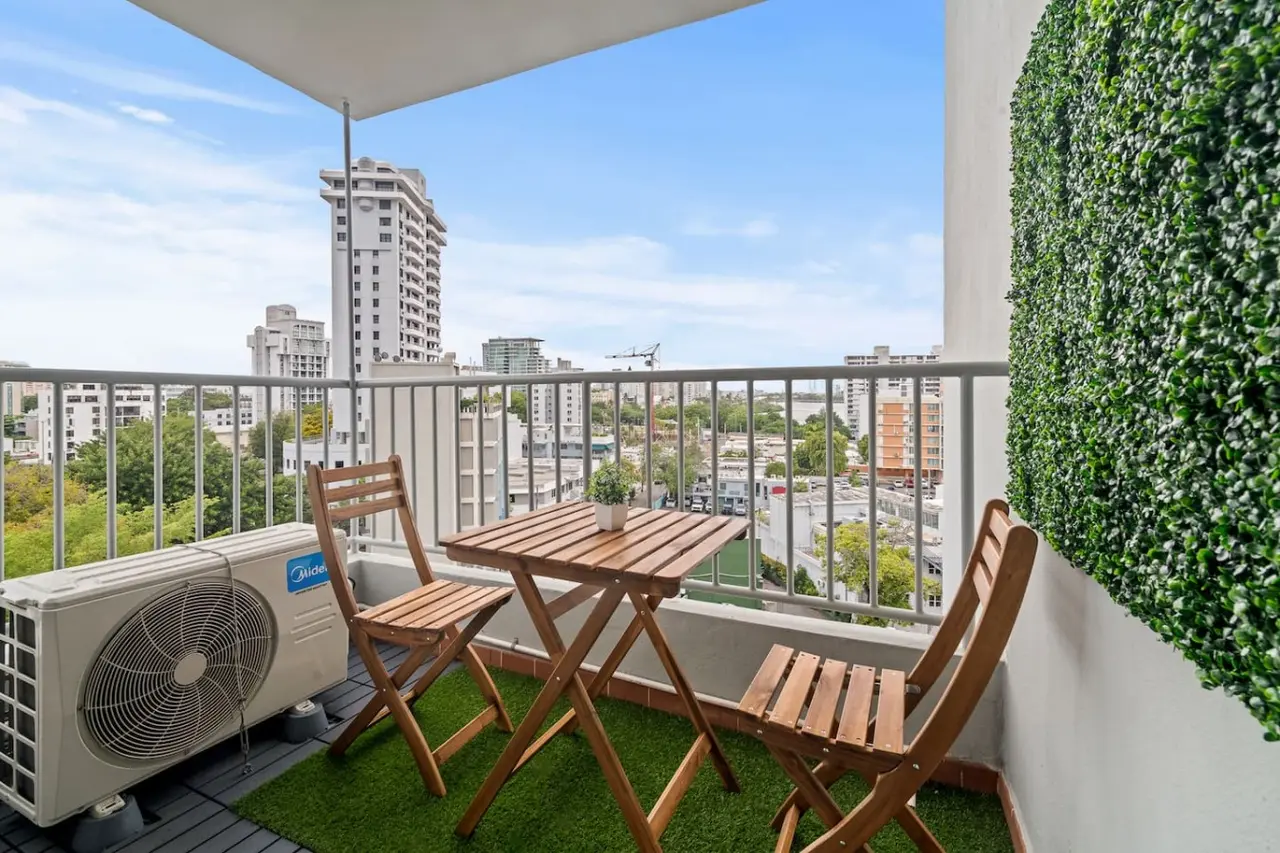 Balcony overlooking a city — High-Rise Condado Suite | Ocean Views & PR Skyline