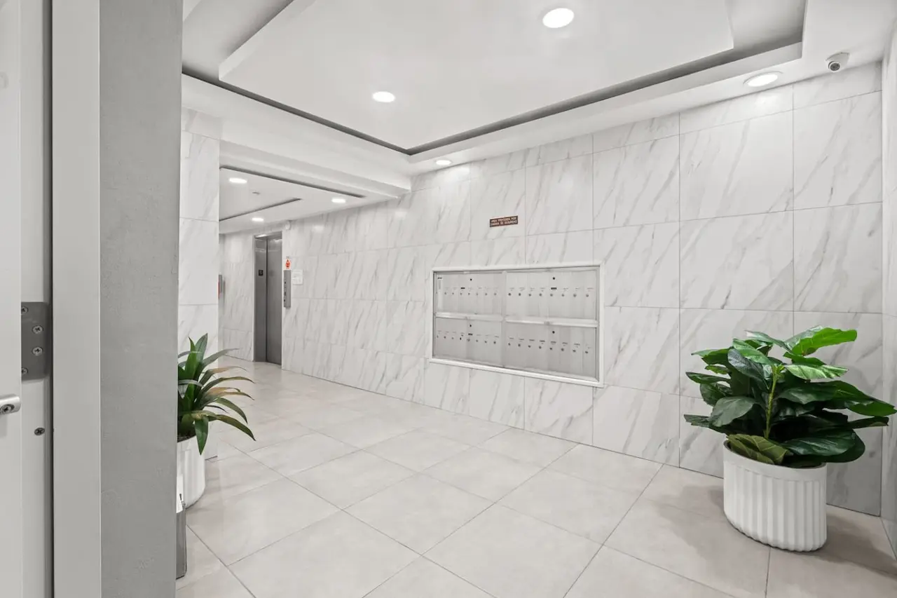 Lobby of the building with marble walls and mailboxes — High-Rise Condado Suite | Ocean Views & PR Skyline