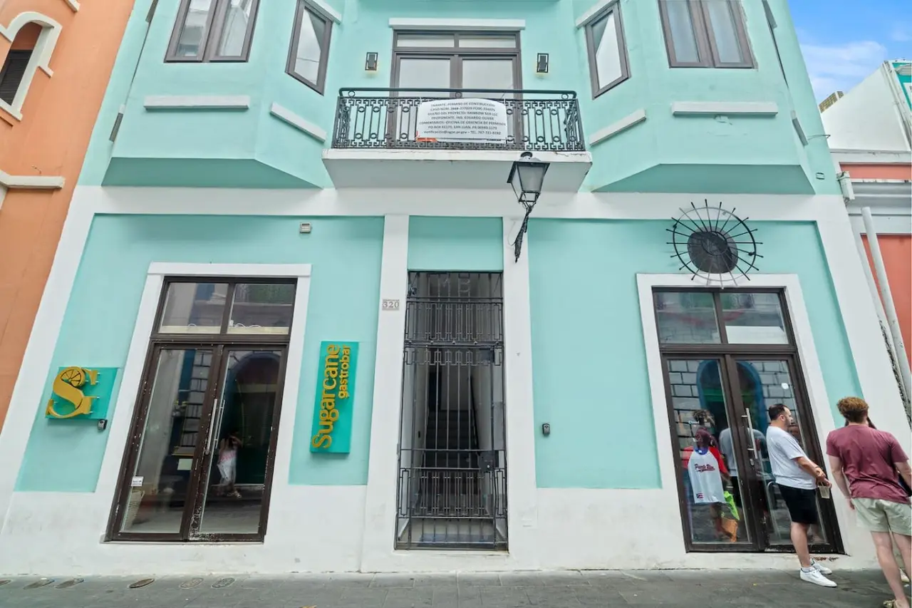 Blue and white building with a green sign on the front — Bellavista Galleria | Old San Juan