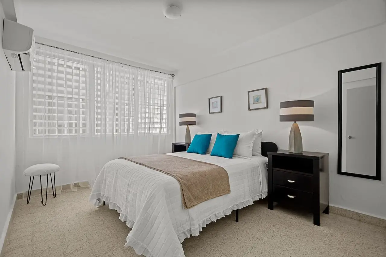 Bedroom with a bed and a lamp on a nightstand — Ocean Park 2BR Backyard BBQ Walk to Beach, Santurce
