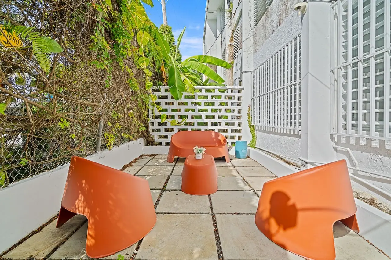 Patio with a table and chairs in front of a building — Ocean Park 2BR Backyard BBQ Walk to Beach, Santurce