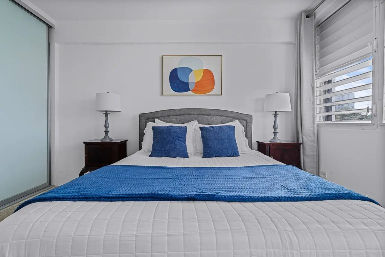 Bedroom with a blue bedspread and blue pillows — Ocean Park 2BR · Steps to Beach & Dining, Santurce