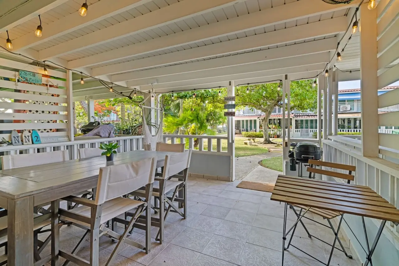 Covered patio with a dining table and a grill — Beachside Villa Dorado Pool Beach Access