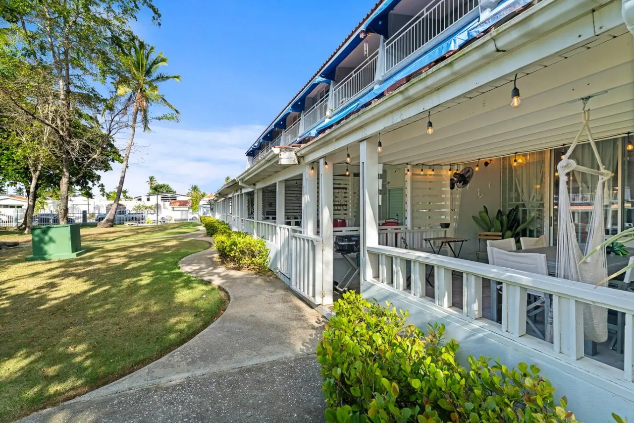 Building with its ground-floor porches and lawn — Beachside Villa Dorado Pool Beach Access