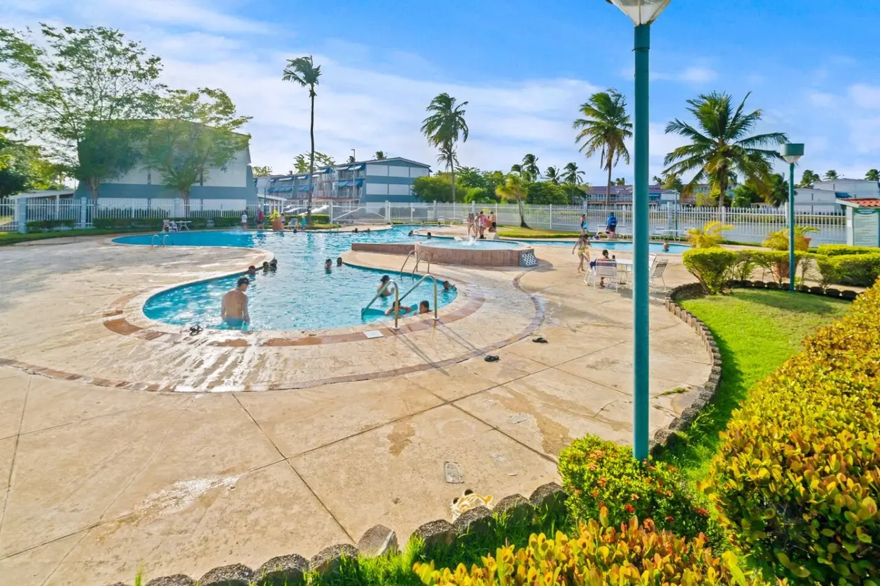 People swimming in a pool — Beachside Villa Dorado Pool Beach Access
