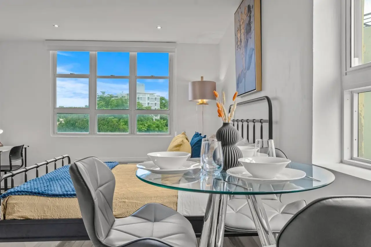 Dining area with a glass table set for two — Caribbean Sea View | T-Mobile District Free Parking, San Juan