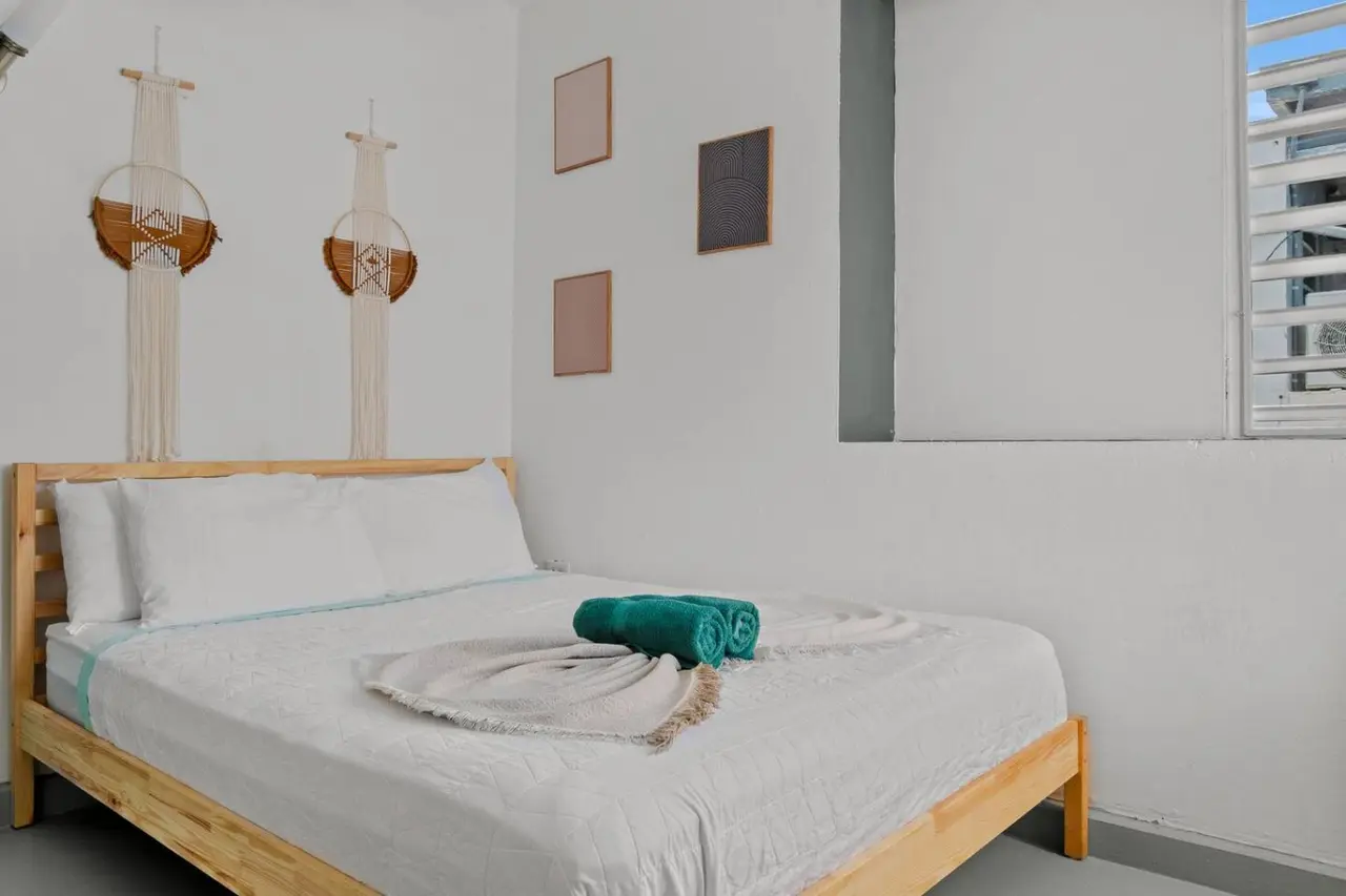 Bedroom with a bed, a rug, and a picture on the wall — Santurce Blue 2BR | Near Beach & La Placita