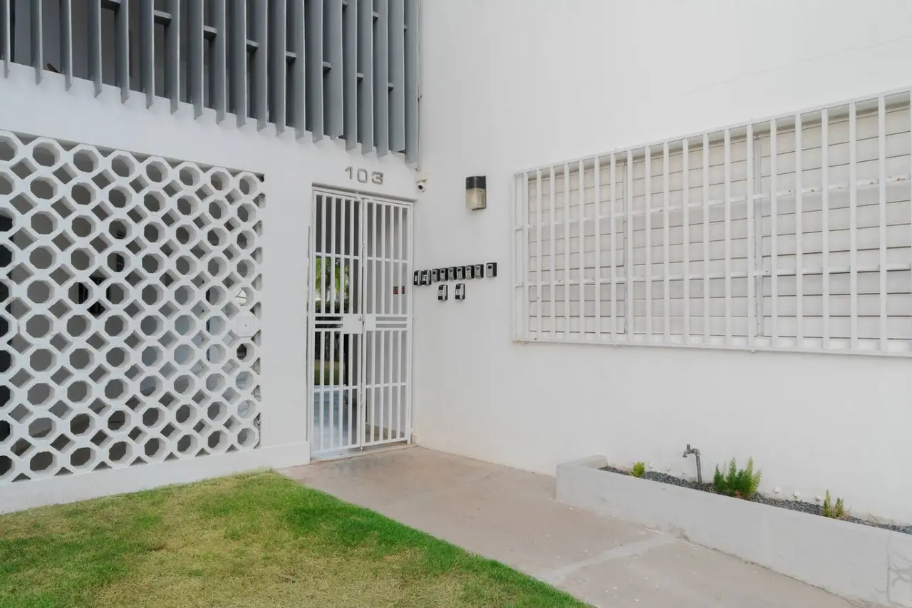 White building with a black door and a balcony — Maré 2BR | Near Ocean Park Beach + Laundry, Santurce
