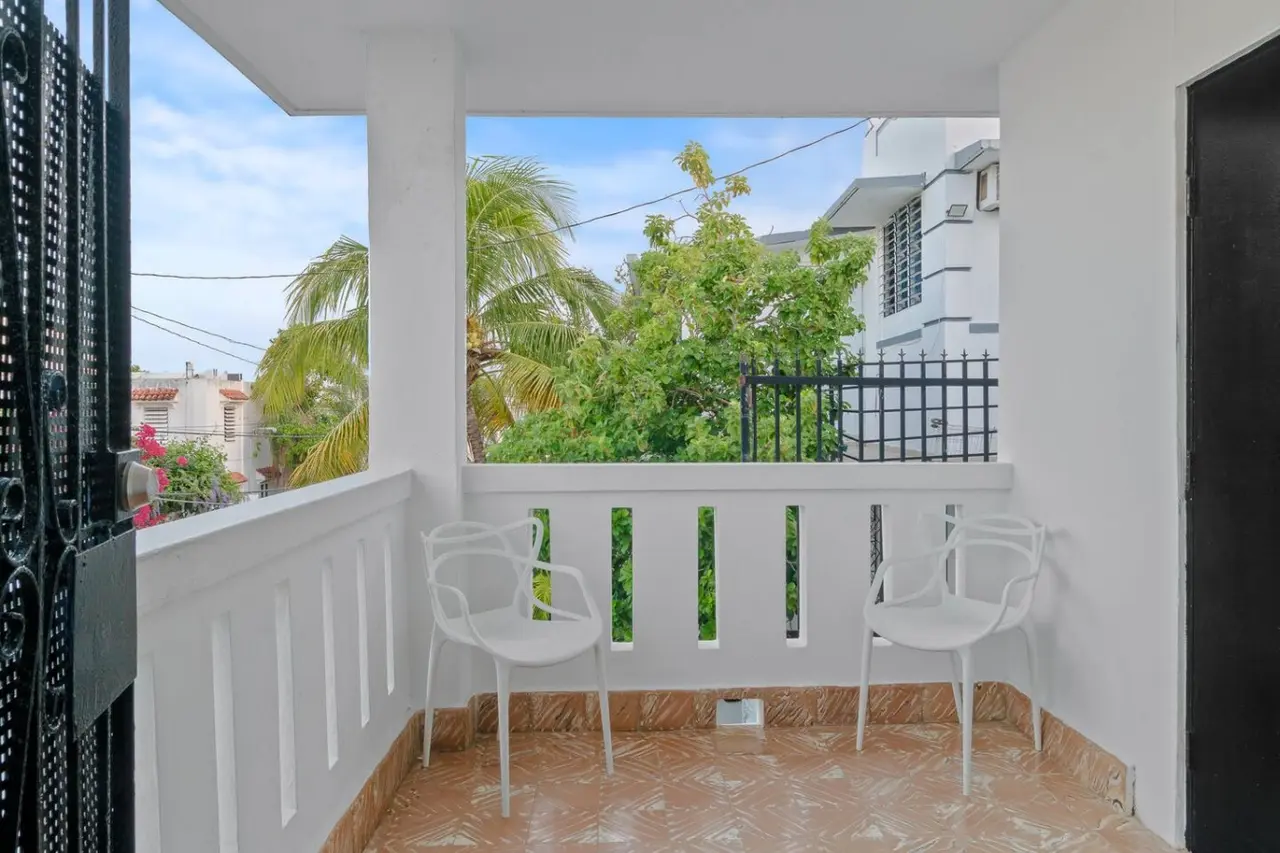 White balcony with two chairs on it — Aurelia | Three Bedrooms in the Heart of San Juan, Santurce