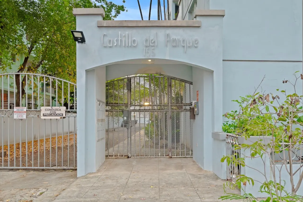 Blue doorway with a metal gate and a sign above it — The Castillo | Sleeps 8 | 2BR + Backyard & Parking, Santurce