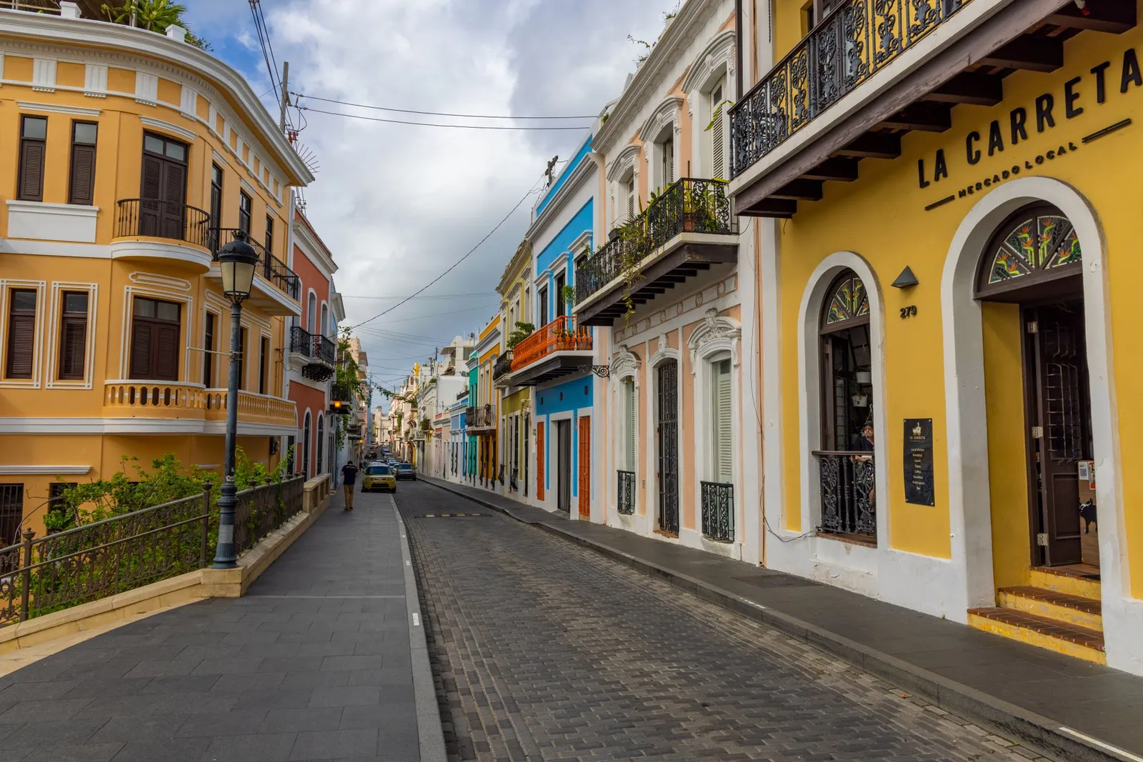 Vibrant historic street view with colorful colonial buildings in Old San Juan, Puerto Rico.